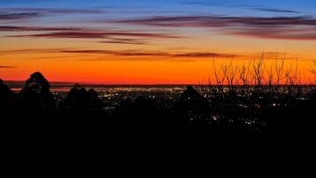 A cityscape at dusk with a sunset sky.