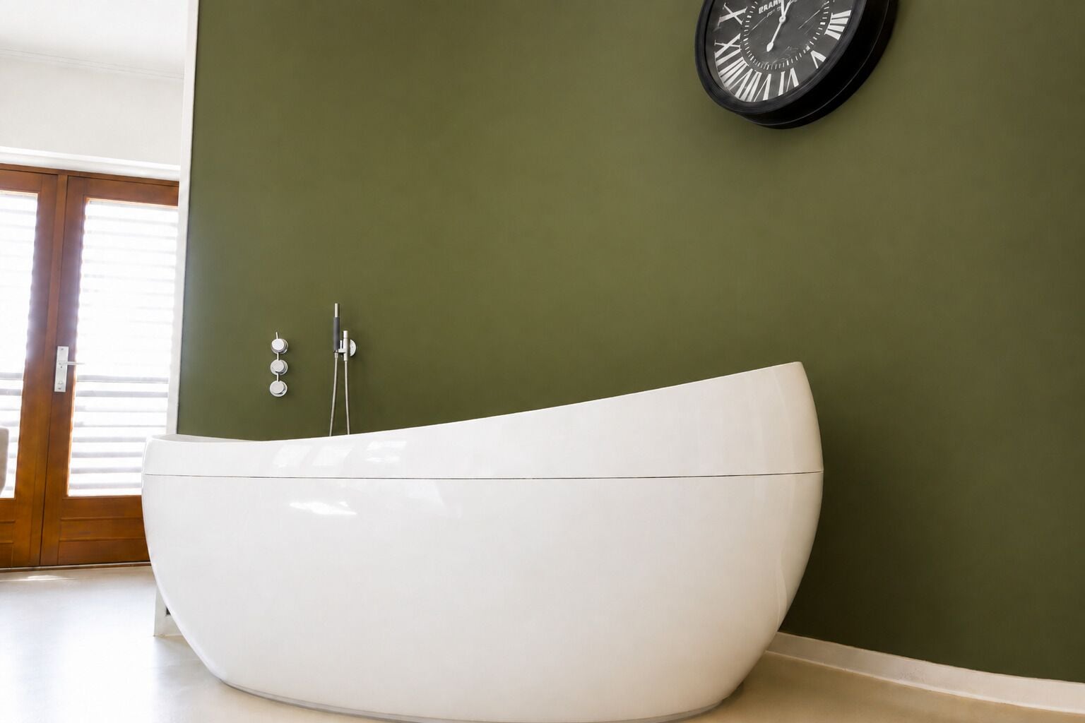 A modern bathroom with a freestanding bathtub, a wall-mounted clock, and a shower with a handheld showerhead.