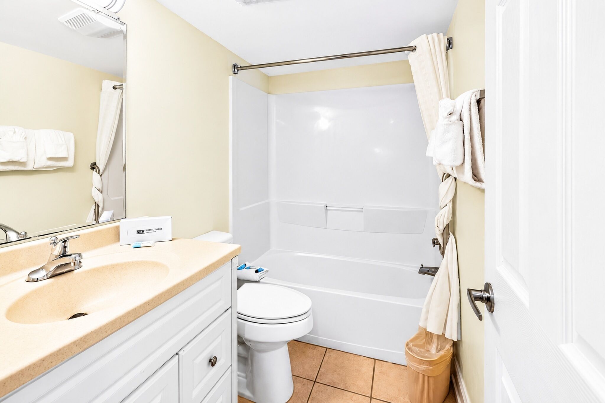 A bathroom with a sink, toilet, and bathtub.