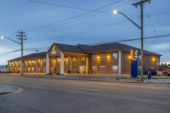 A Comfort Inn & Suites hotel with a brick facade, multiple windows, and a well-lit entrance. - Comfort Inn (Dawson Creek)