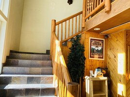 Puinen portaikko, joka johtaa mökkialueelle, ja alueen sisäänkäynnillä on kyltti, jossa lukee Bear Creek Resort.