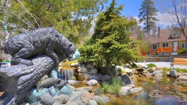 A serene garden with a pond, rocks, and a bear sculpture. - Bear Creek Resort (Big Bear Lake)