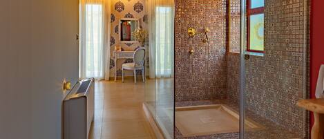 A bathroom with a shower, a sink, and a mirror.