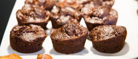 A tray of chocolate muffins on a white plate.