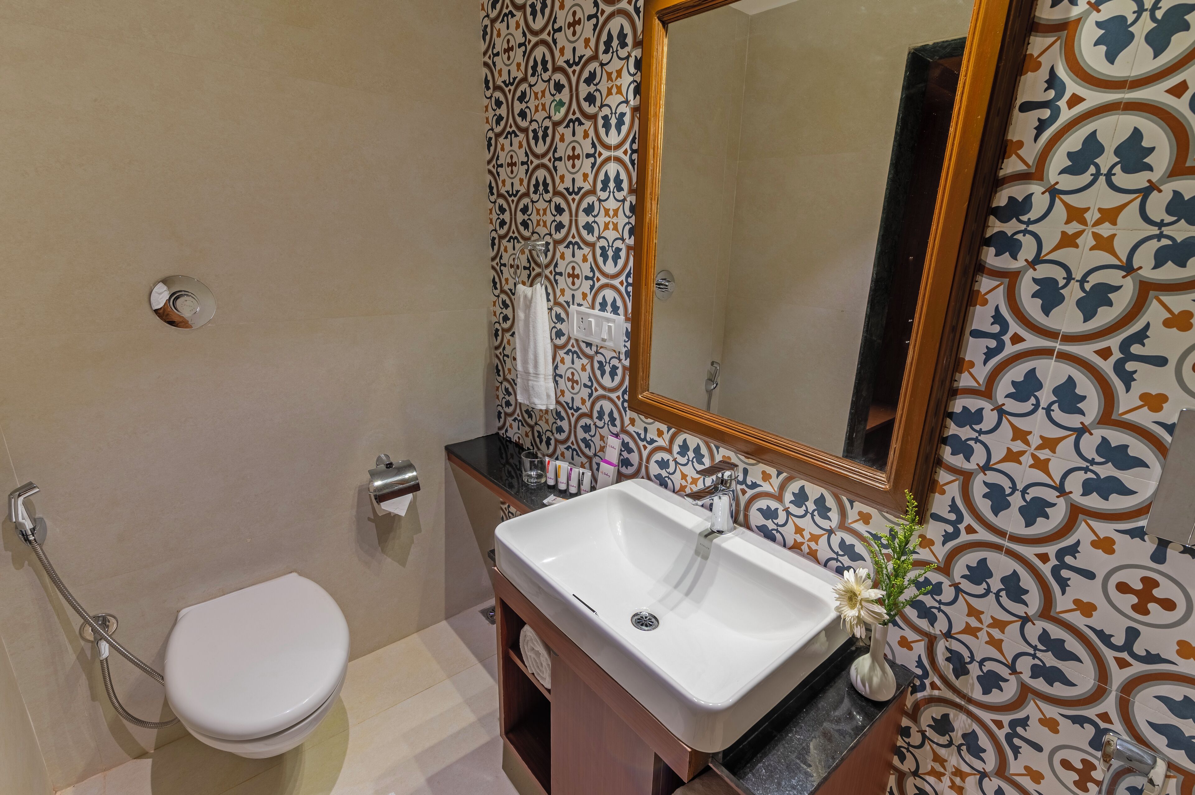 A bathroom with a toilet, sink, and shower.