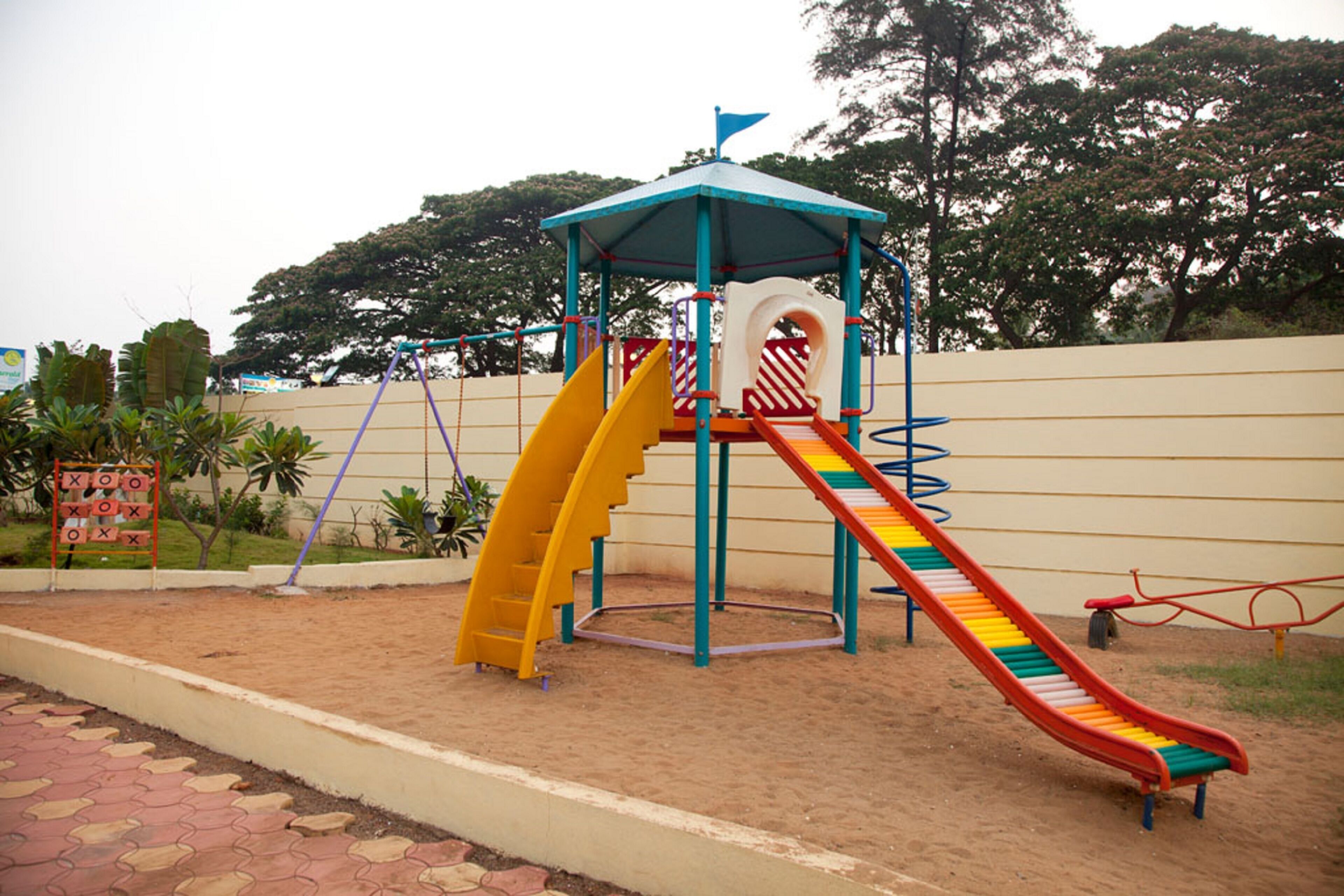 A playground with a slide and climbing structures.
