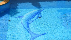 Piscina com design em mosaico e área de hidromassagem.