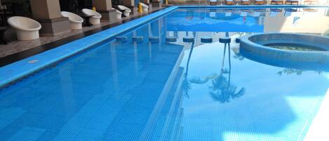 Outdoor pool, open 9 AM to 9 PM, pool loungers