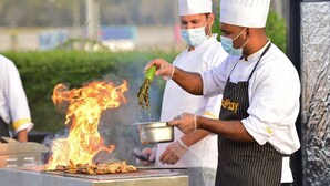 Chefs grilling food outdoors with flames visible. - PrideInn Hotel Diani (Diani Beach)