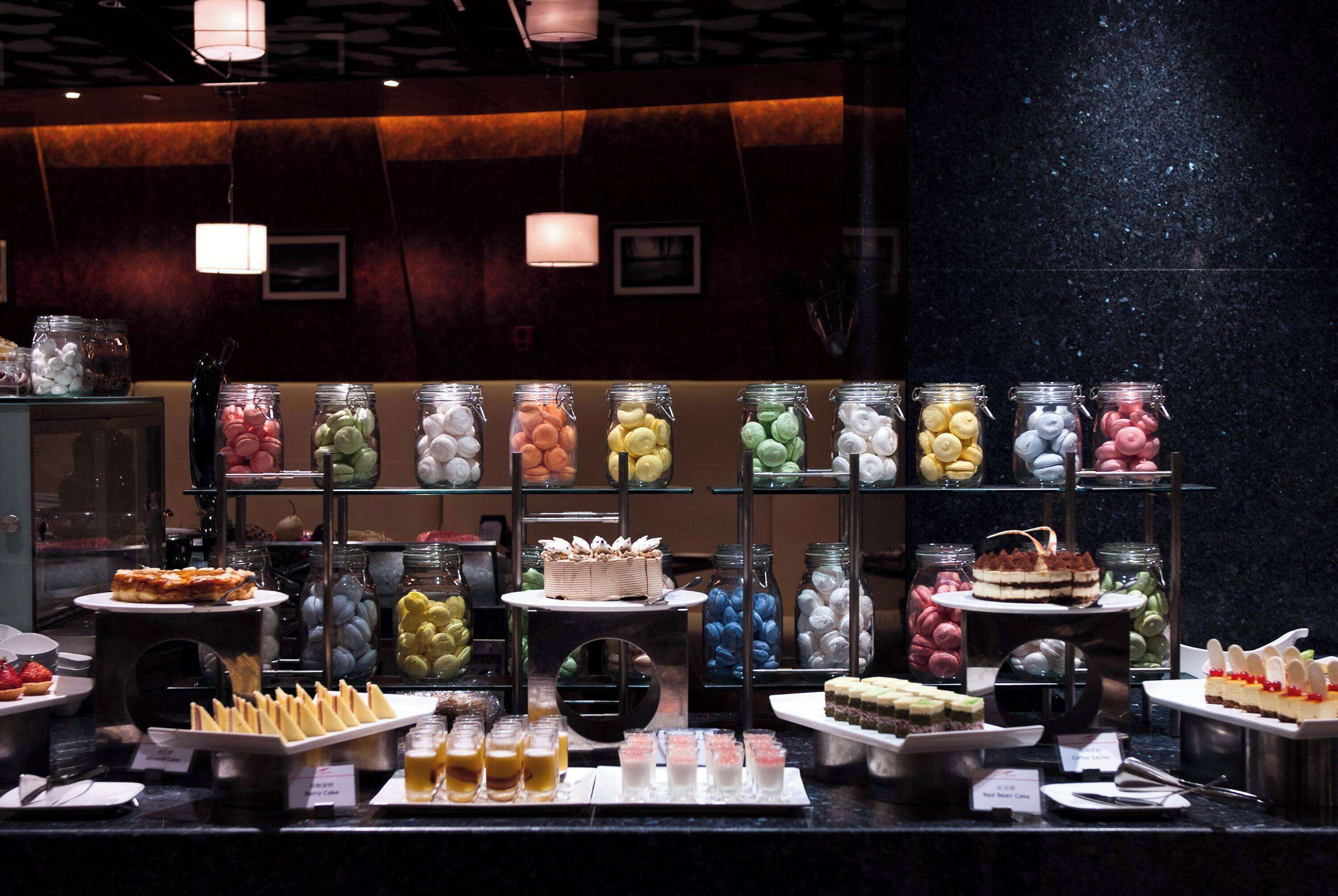 A buffet with various food items and desserts.