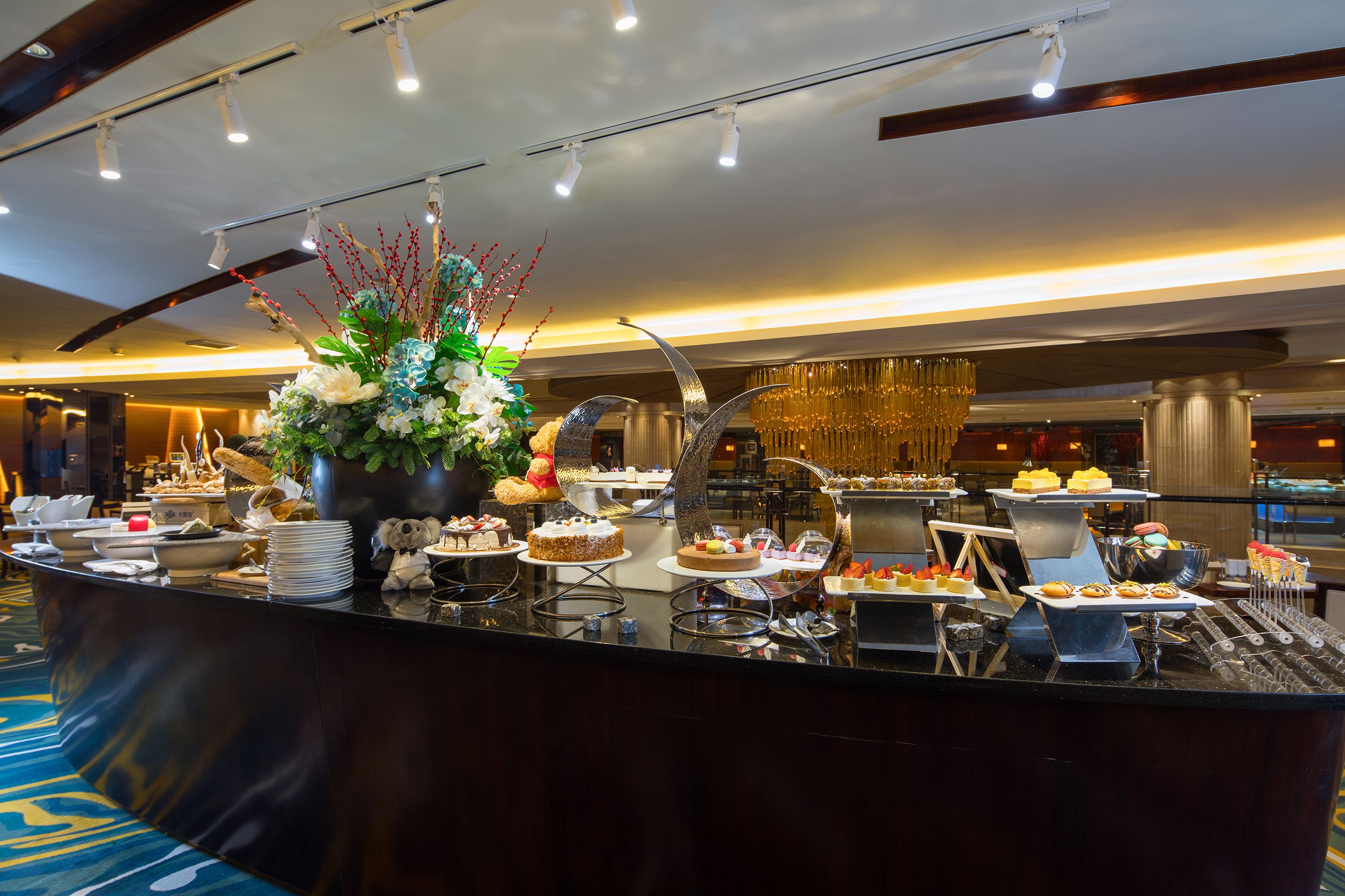 A buffet area with various food items and a decorative centerpiece.