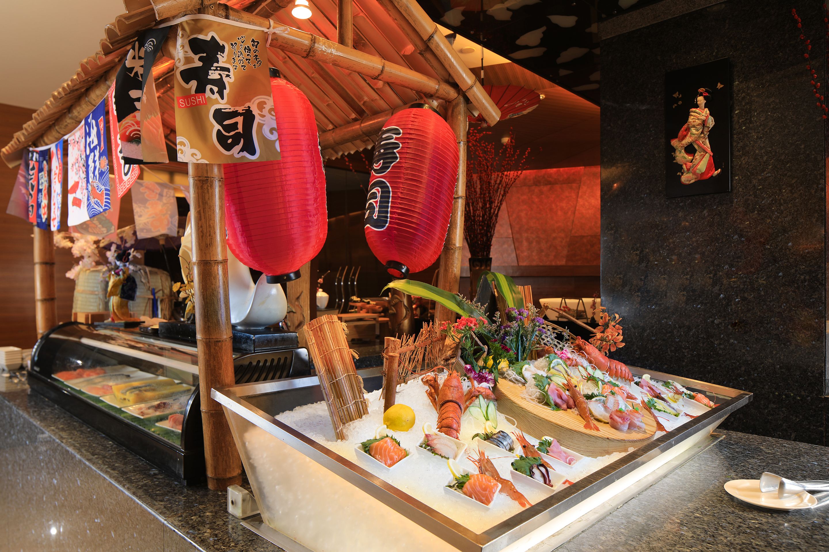 A sushi display with various types of sushi and a decorative lantern.