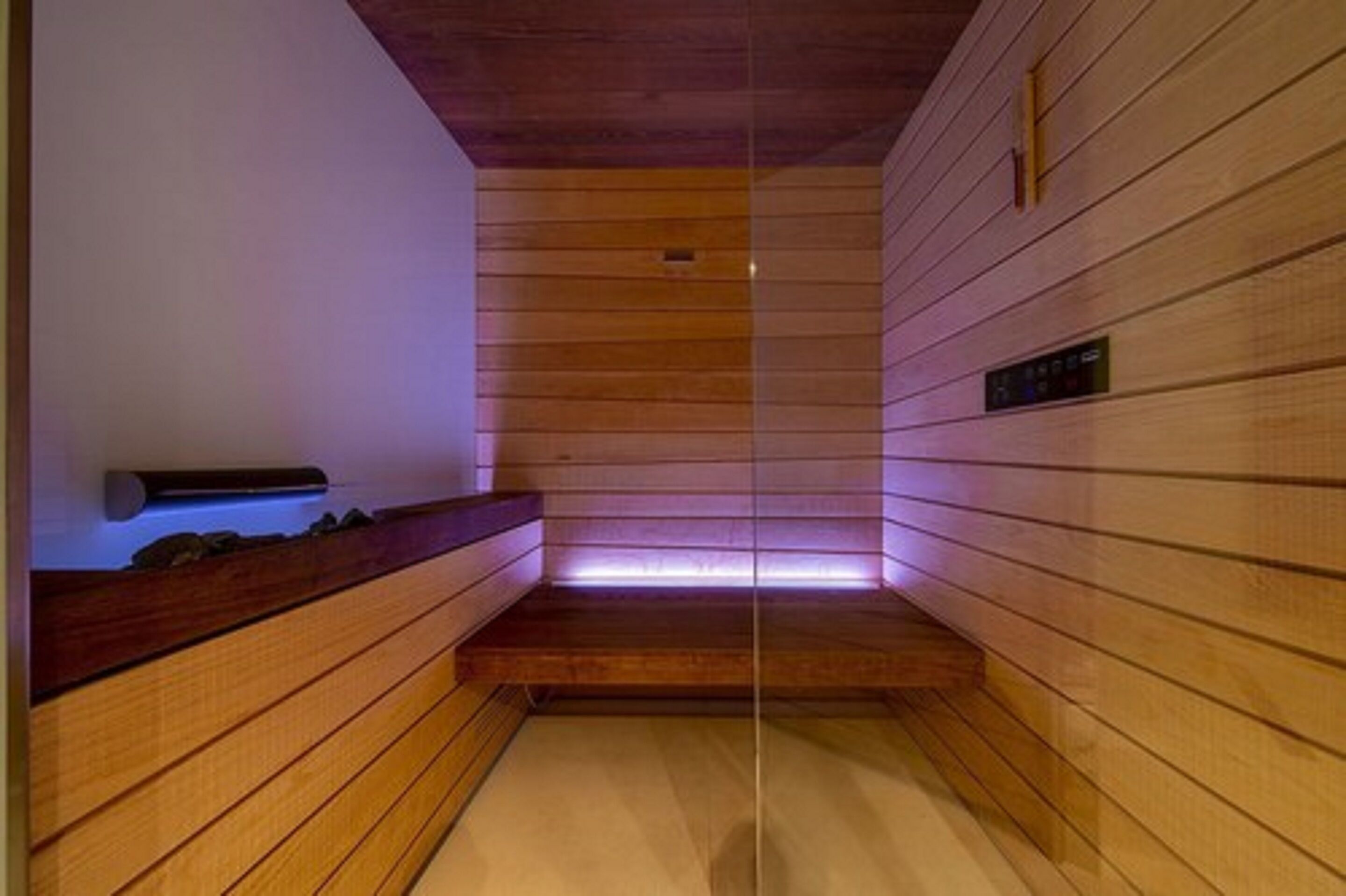 A sauna with wooden walls and a bench.