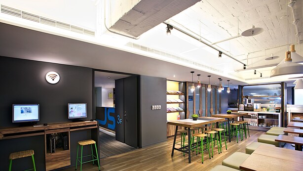 A modern office space with desks, chairs, and a kitchenette area. - Just Sleep Taipei Linsen (Taipei)