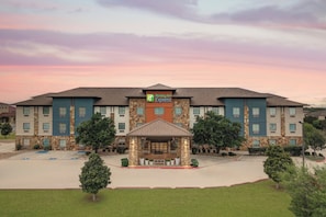 A Holiday Inn Express hotel with a stone facade, multiple floors, and a central entrance. - Holiday Inn Express Marble Falls by IHG (Marble Falls)