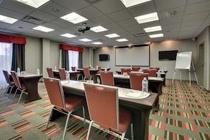 Meetings and presentations come alive in this well-equipped conference room with a large table, comfortable seating, and modern amenities.