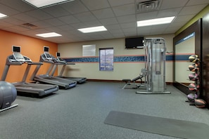 Stay fit with our well-equipped gym featuring treadmills, a weight machine, and exercise balls.
