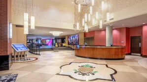 A hotel lobby with a reception desk, a large pineapple-themed floor design, and a modern chandelier. - Staypineapple, The Maxwell Hotel, Seattle Center Seattle (Seattle)
