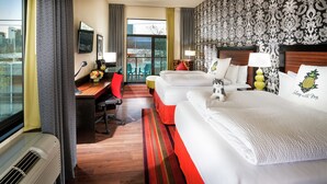 A hotel room with two beds, a desk, a chair, and a view of the city. - Staypineapple, The Maxwell Hotel, Seattle Center Seattle (Seattle)