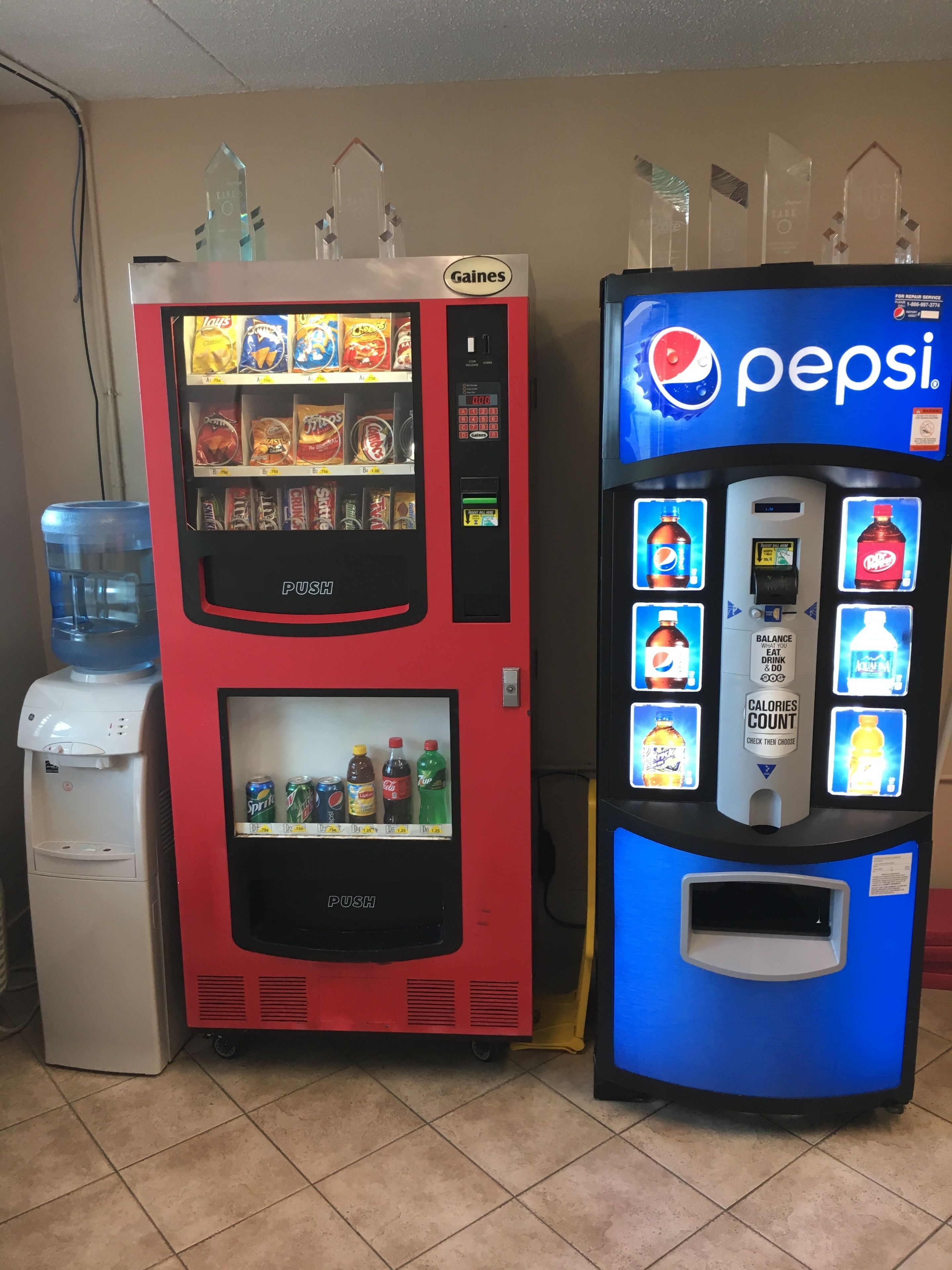 Two vending machines, one with snacks and the other with beverages, including Pepsi.