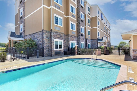Seasonal outdoor pool, open 9:00 AM to 10:00 PM, pool umbrellas