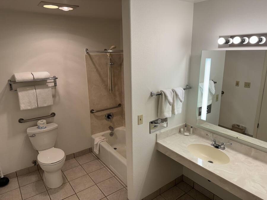 A bathroom with a toilet, bathtub, and sink.