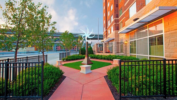 A building with a brick facade, large windows, and a central sculpture. - Residence Inn by Marriott Pittsburgh North Shore (Pittsburgh)