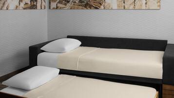 A modern bedroom with a bed, a bench, and a wall-mounted artwork.