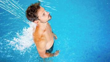 A person swimming in a pool.