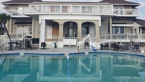 A two-story house with a swimming pool in front. - Topaz Motel (Flagler Beach)