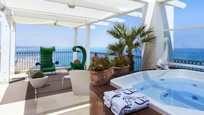 A balcony with a hot tub, potted plants, and a view of the sea. - Posillipo (Gabicce Mare)
