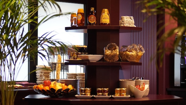A buffet setup with various food items and condiments. - Kyriad - Caen Centre (Caen)