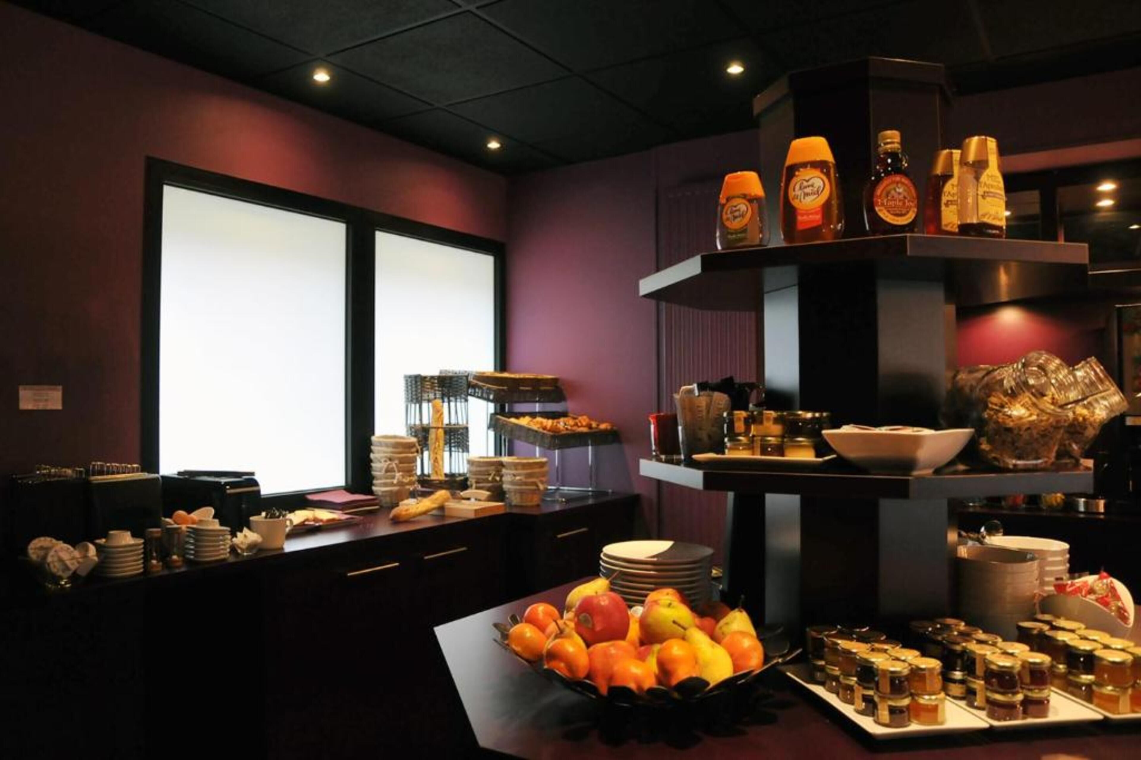 A buffet setup with various food items and condiments.