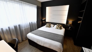 A modern hotel room with a large bed, bedside tables, a desk, and a wardrobe. - Kyriad - Caen Centre (Caen)