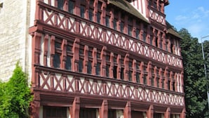 A traditional half-timbered building with a symmetrical facade, large windows, and a prominent entrance. - Kyriad - Caen Centre (Caen)