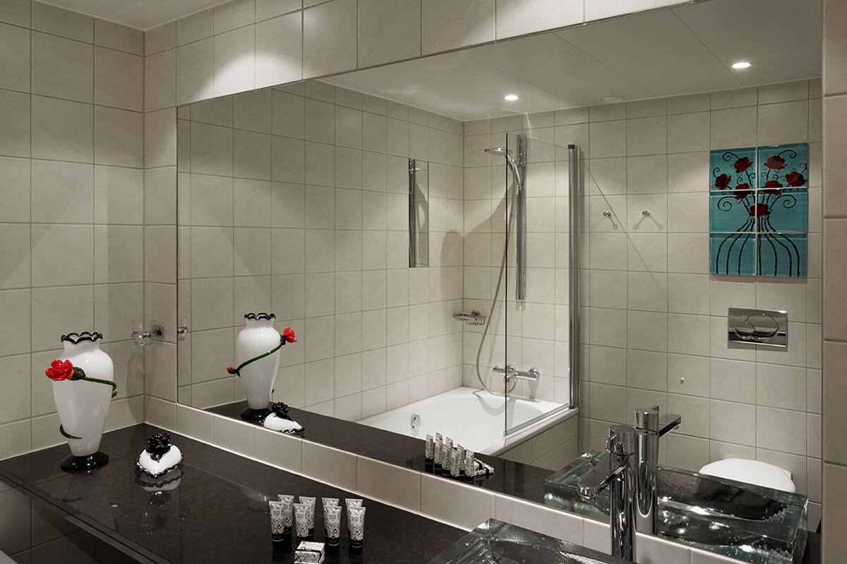 executive studio suite | bathroom | designer toiletries, hair dryer, bathrobes, slippers