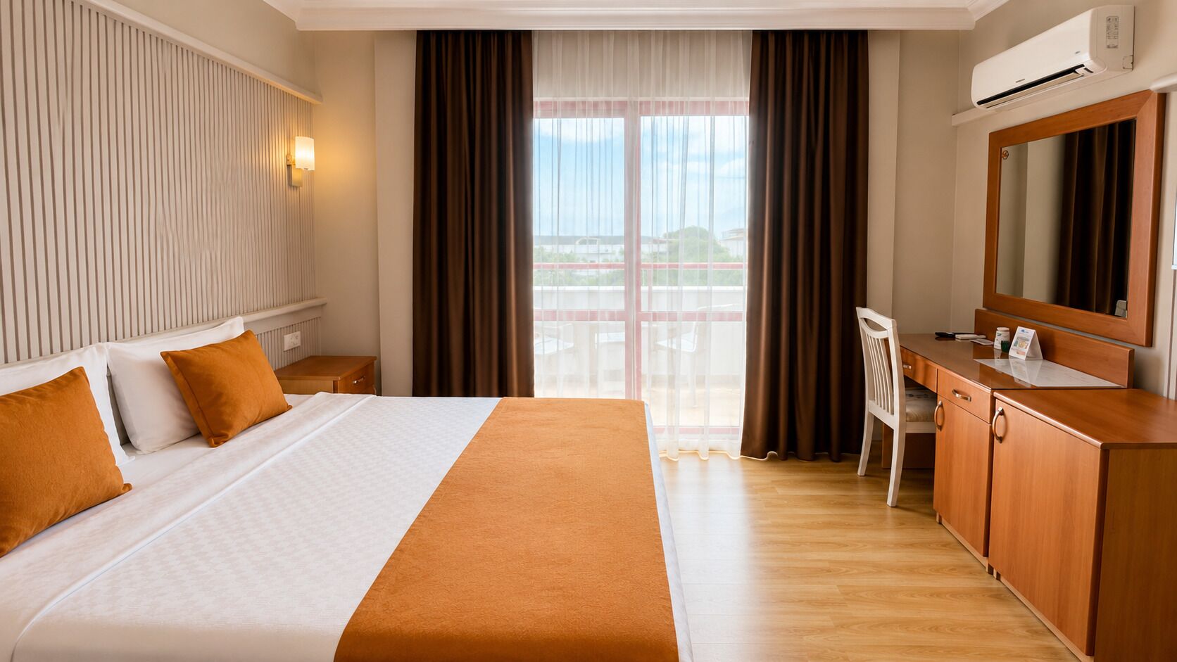 A hotel room with a bed, a desk, a chair, an air conditioning unit, and a view through the window.
