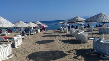 White sand, sun-loungers, beach umbrellas, beach volleyball
