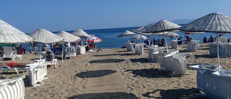 White sand, sun-loungers, beach umbrellas, beach volleyball