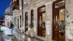 A hotel facade with large wooden doors, a sign for 'Civitatas Rethymnae Boutique Hotel', and potted plants. - Civitas Suites Hotel (Rethymno)