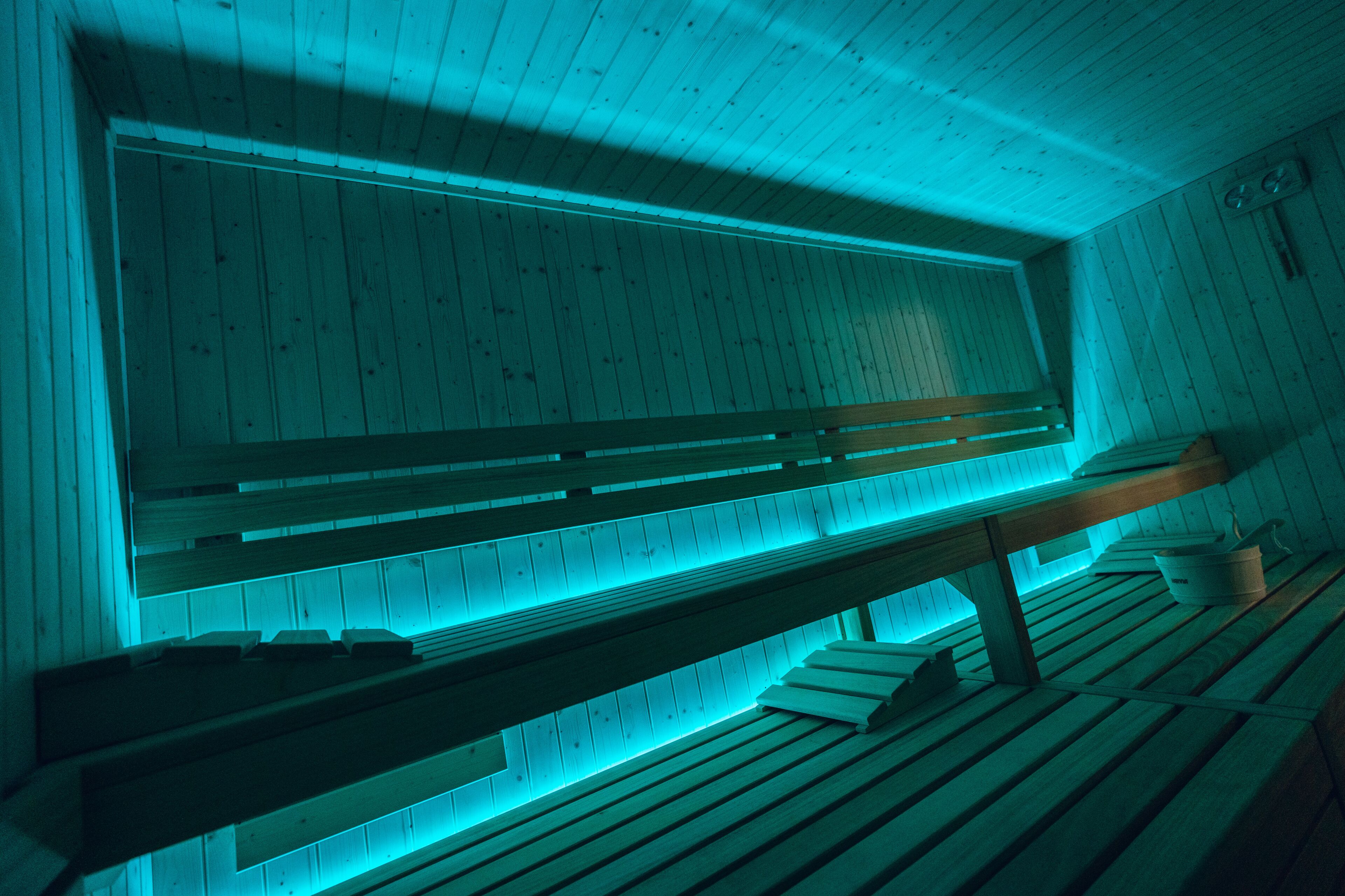 A wooden sauna with benches and a bench seat.
