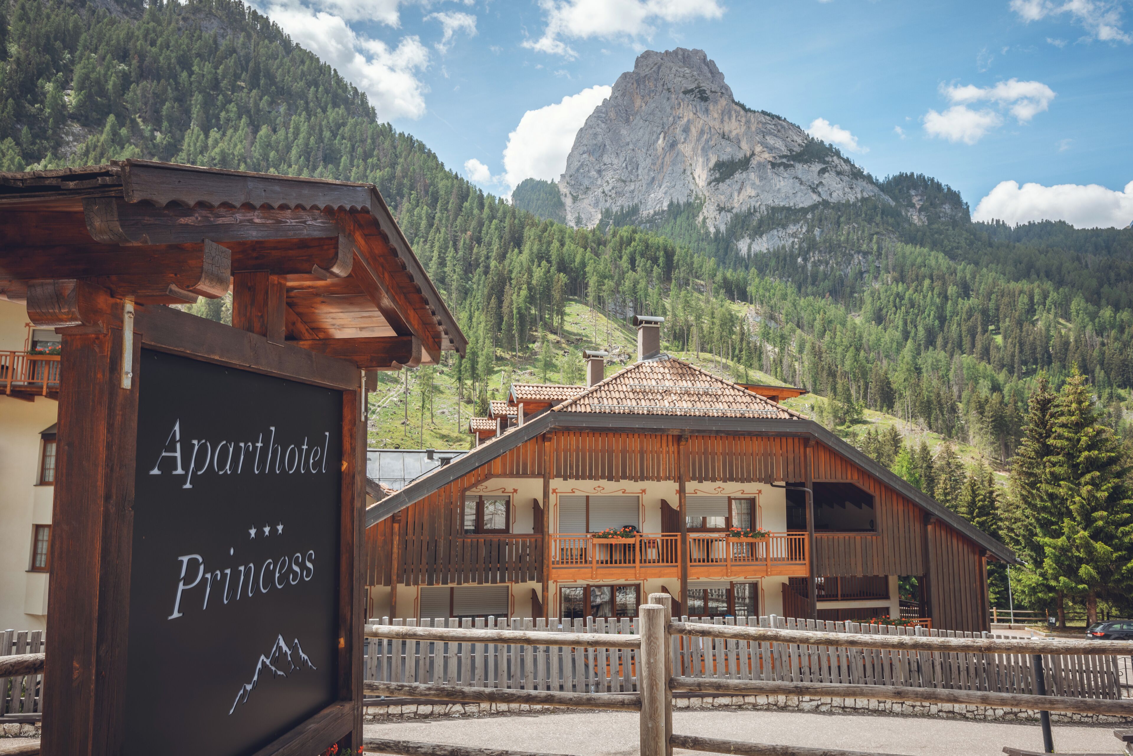 A wooden building with a sign reading 'Aparthotel Princess'.