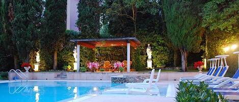 Seasonal outdoor pool, open 10:00 AM to 7:00 PM, pool umbrellas