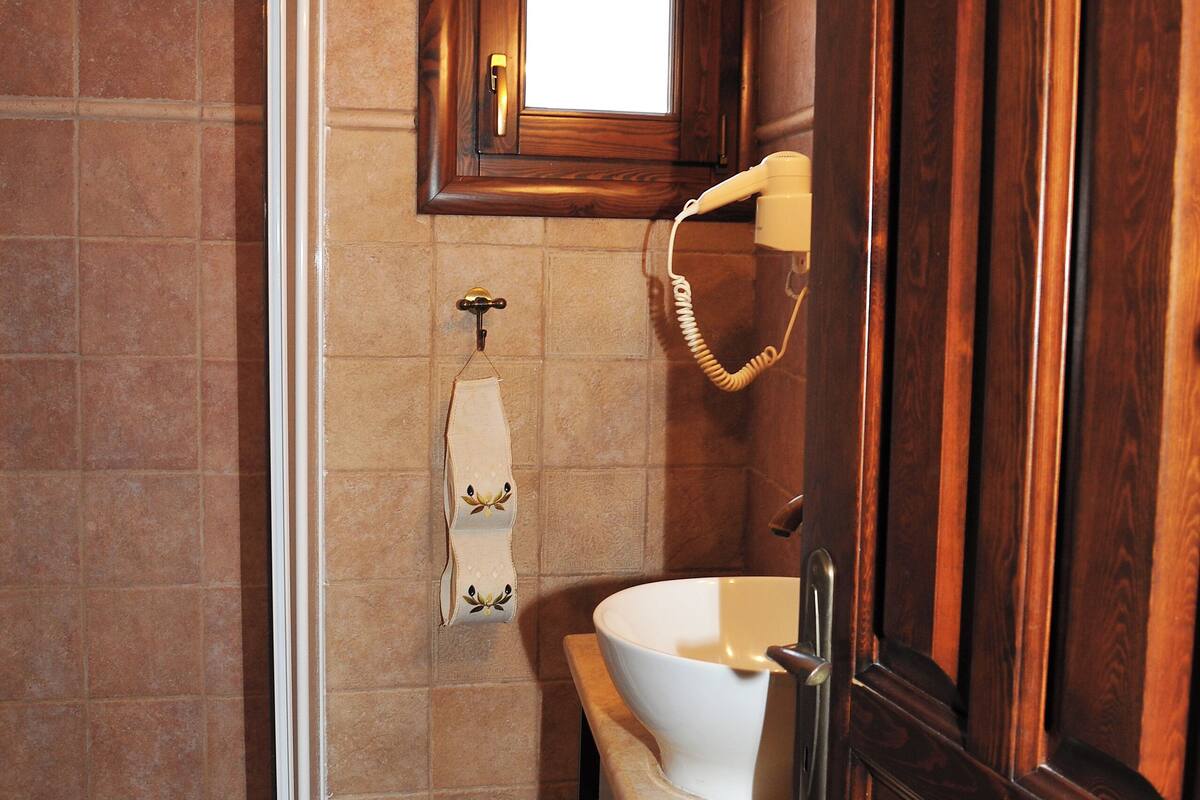 deluxe apartment, 1 queen bed with sofa bed | bathroom | hair dryer, slippers, towels