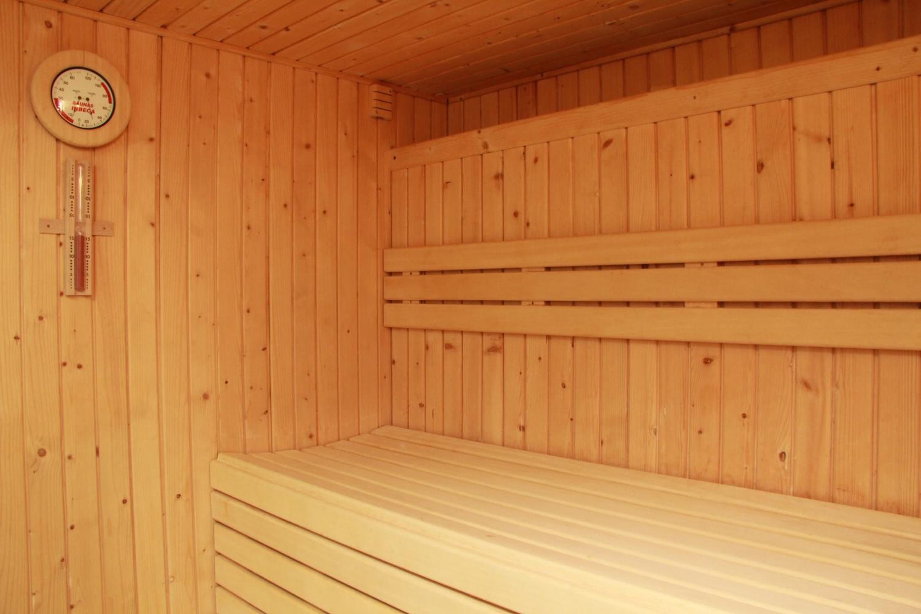 Sauna, jossa on puuseinät ja -lauteet.