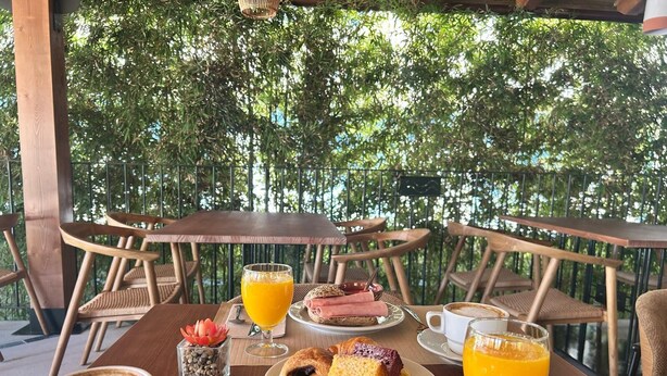 A breakfast setting with a table, chairs, and a view of trees. - Del Mar Hotel & Spa (El Puerto de Santa Maria)