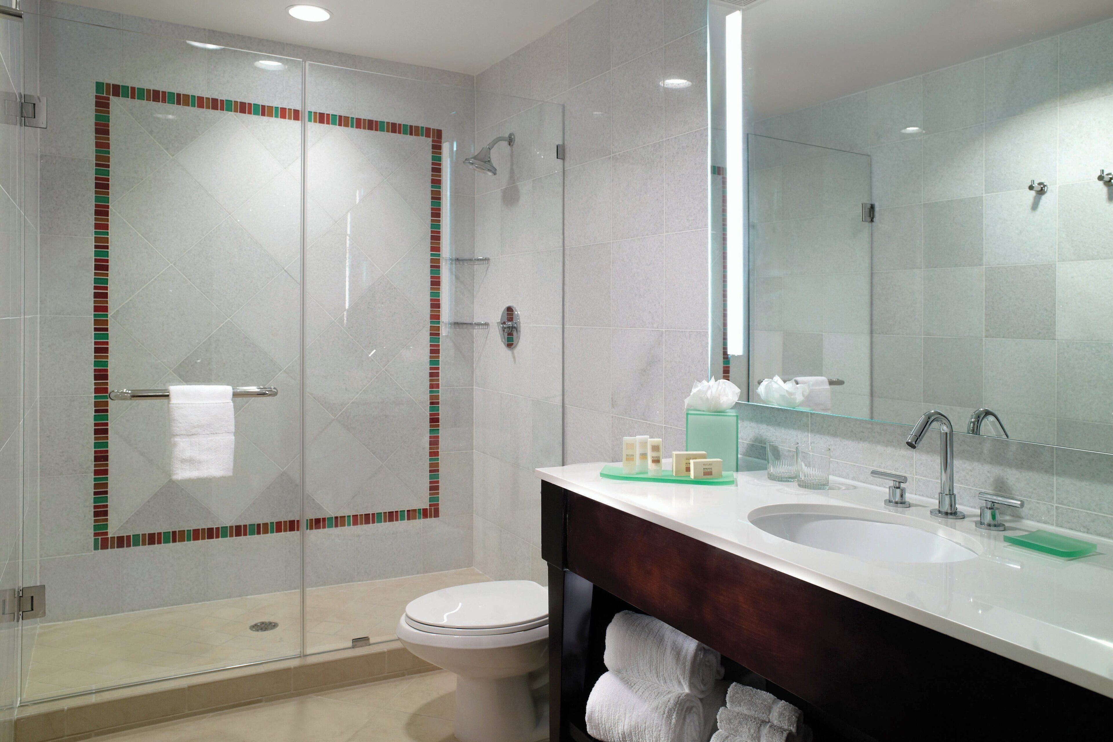 combined shower/bathtub, designer toiletries, hair dryer, towels