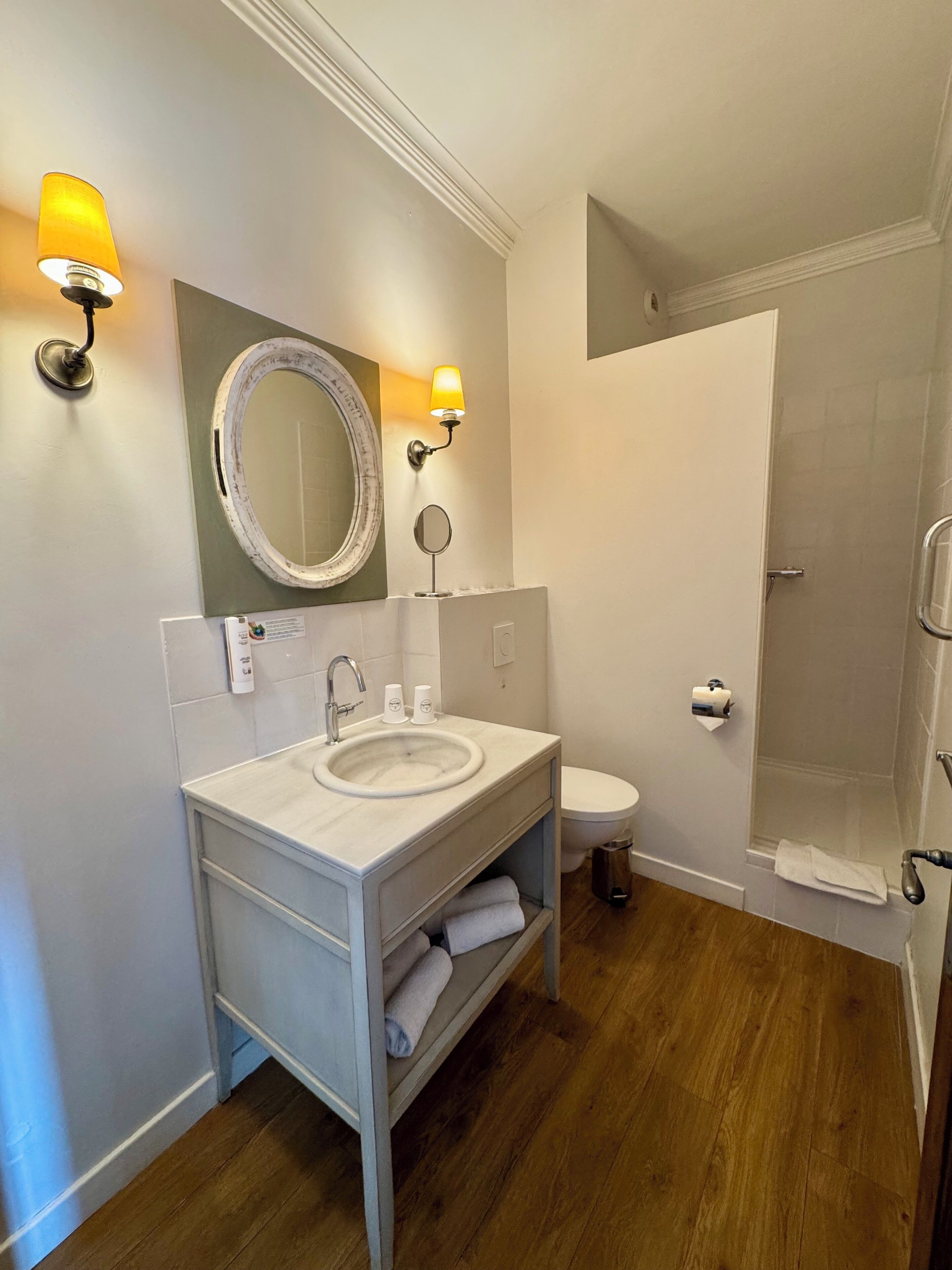 Un baño con lavabo, espejo, inodoro y ducha.