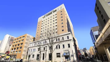 Stunning building with a mix of modern and traditional architectural styles, set amidst a tranquil urban landscape.