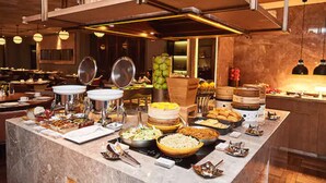 A buffet setup with various food items and serving utensils. - Jinjiang Metropolo Hotel Classiq, YMCA (Shanghai)